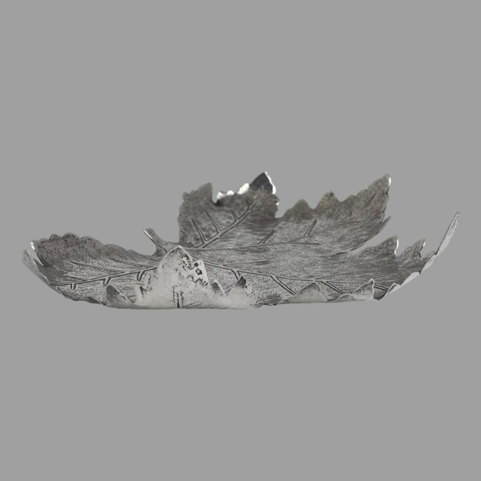 Photo of the silver maple leaf dish this time shown from a slightly raised angle from the side.