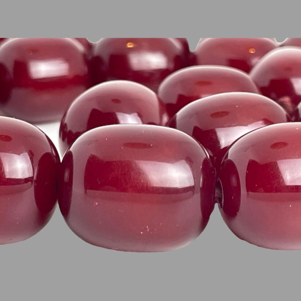 A close up photo of some of the cherry amber bakelite beads.