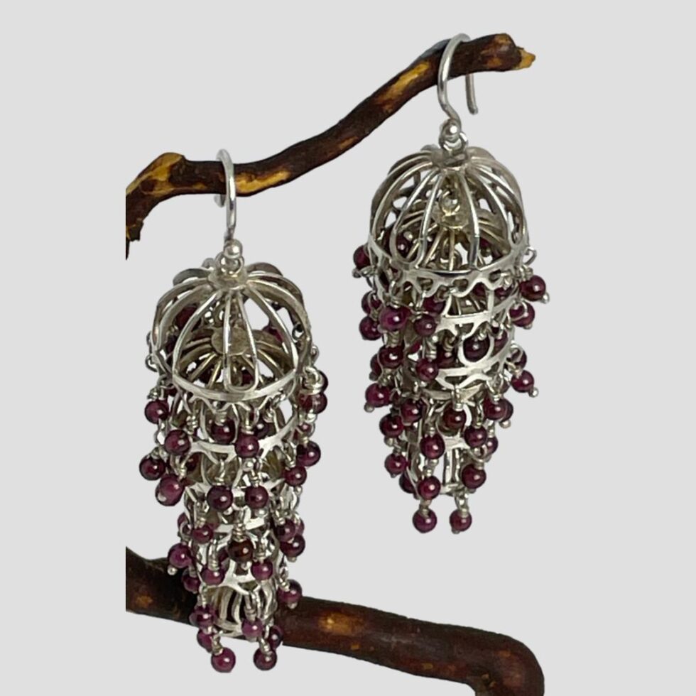 Another angle look of the silver garnet chandelier earrings this time looking diagonally down from the top. The chandelier effect with the graduating sizes of the birdcage domes clearly visible.