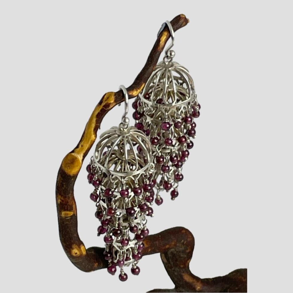 Another photo looking down at the earrings from above this time from a side view with one earring lower and in the foreground. Again, this is to show the graduating articulated design.