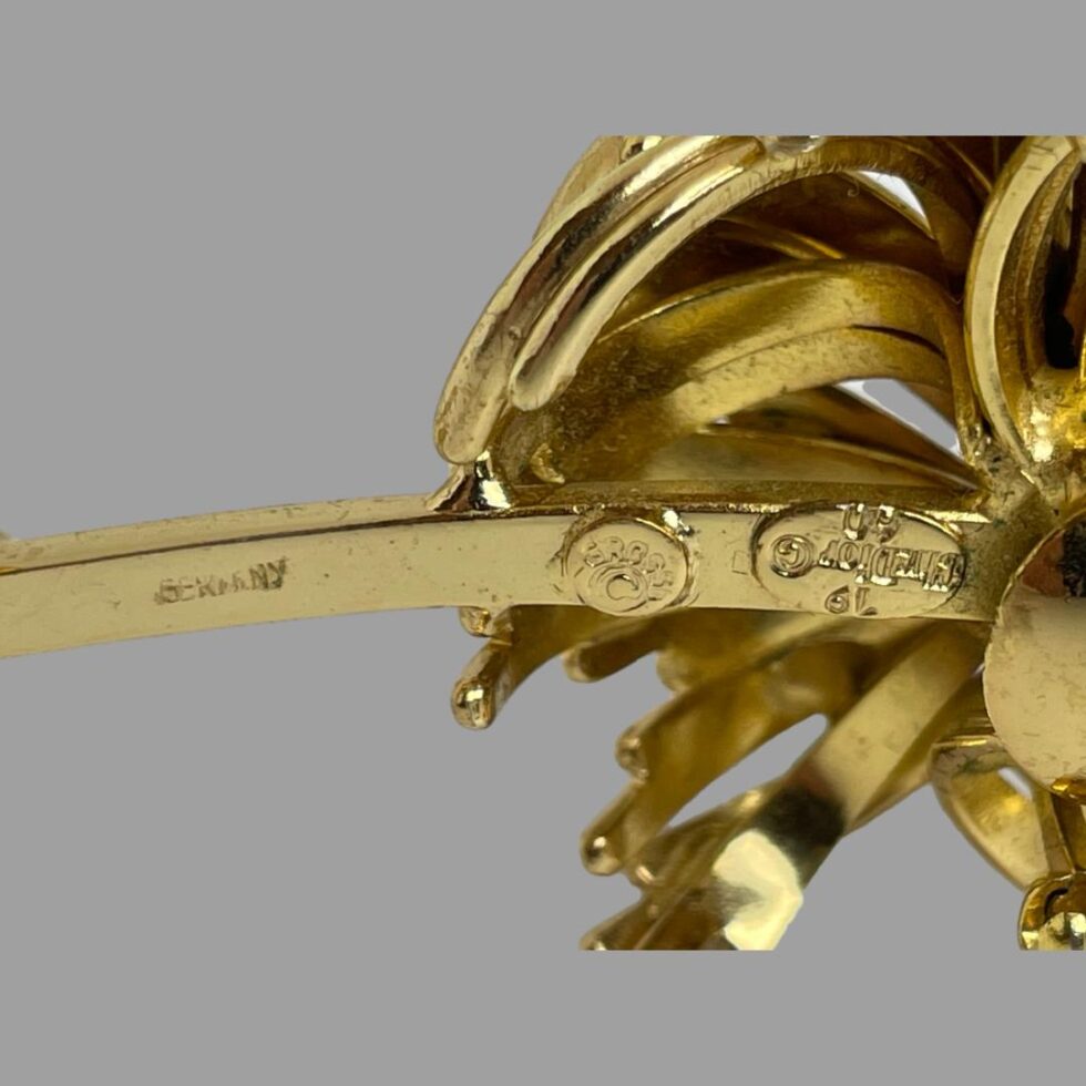 Close up photo of the stamps at the back. Germany is visible on the left on the stem with Grosse in the middle and Chr.Dior on right just below the flower head and upside down.
