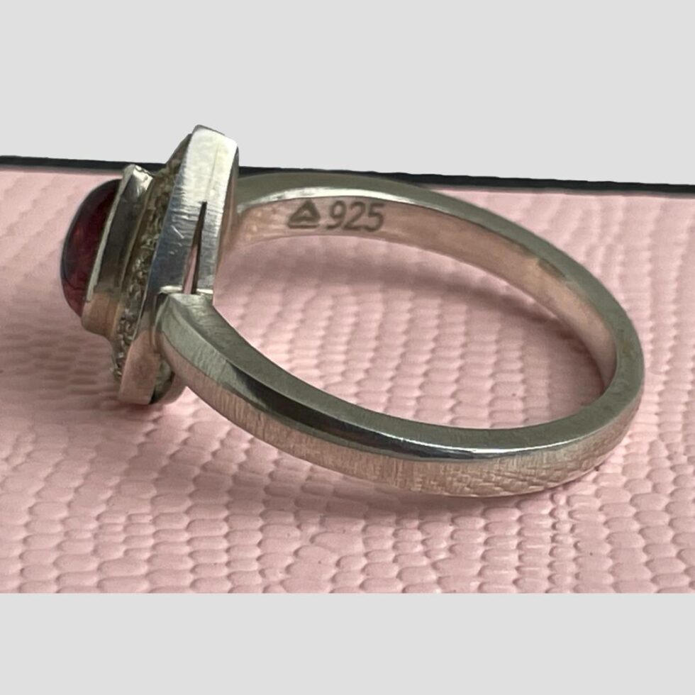 Photo of tourmaline & sapphire ring still displayed on top of its box this time with ring front facing left and the 925 hallmark visible inside the band.
