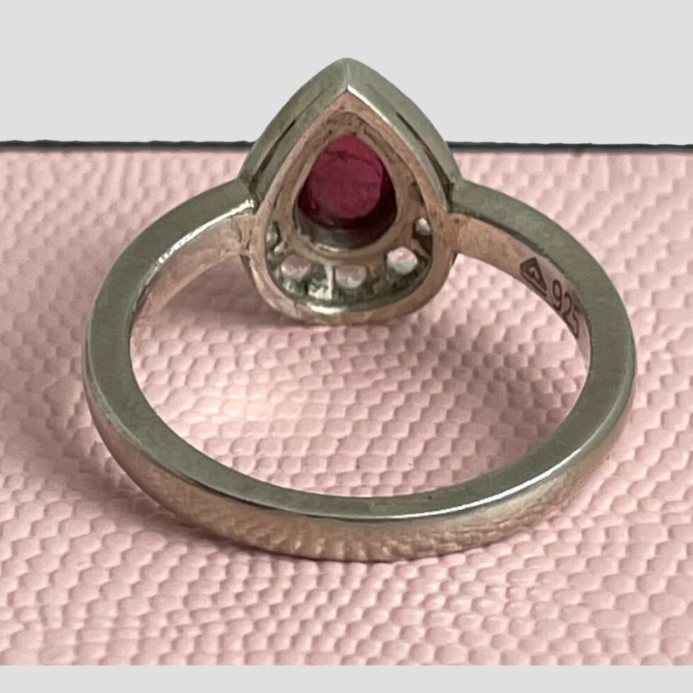 Photo of the cerise tourmaline ring seen from the back showing the setting of the stones. The sterling silver setting is solid with a generous thickness band.