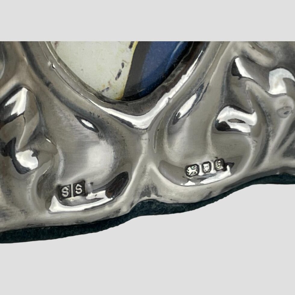 Close up photo of the bottom of the frame showing the makers initials SS to the left and the full hallmark to the right.