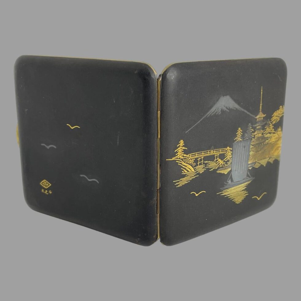 Photo of Japanese damascene cigarette case displayed open and upright with the front and back designs visible. The front design we have seen in detail the back is has 3 birds - 2 silver and 1 gold with a stylised signature and K24 in the bottom left corner.
