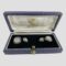 Main photo of white gold sapphire cufflinks displayed inside the Garrard & Co cufflinks box. The open box is forward facing with the cufflinks securely in place to the left and right. The box has a blue exterior, an almost black blue velvet inner and white silk lined inside the lid with Garrard & Co details in gilt. The larger of the link squares are on the outer extremes and the smaller squares inside. The cufflinks design - all uniform except size - square shaped but with rounded edges. A carved rock crystal sits in the centre of each also round-cornered squares. The carving in the crystal is lines emanating from the small round cut diamond at the centre. Around the perimeter is a frame of Channel set sapphires and all set in 18 karat white gold. Each area, the diamond, the rock crystal and the sapphires are separated with a white gold frame - the frame around the diamond is plain white gold whereas the frames around the rock crystal and sapphires have notches all the way around. An incredibly striking pair of cufflinks for the discerning man in your life!