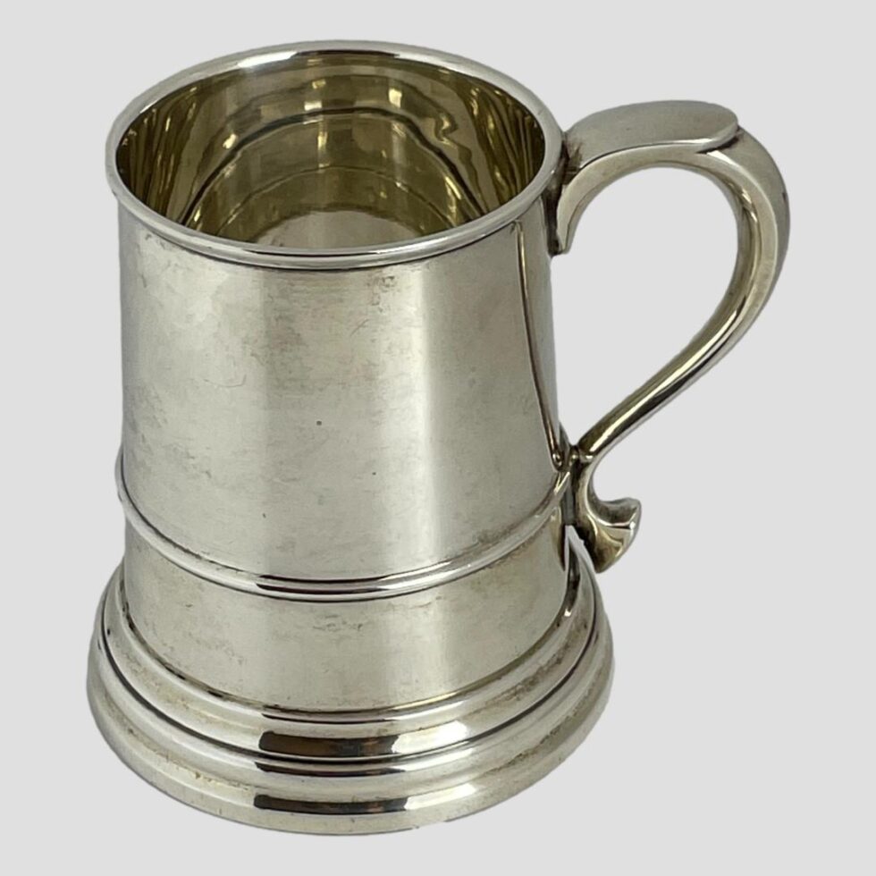 Photo of the other side of the tankard taken from a little raised angle looking diagonally down and peering into the top. The tankard has no decoration or markings other than the hallmark so is a blank canvas to personalise to your hearts content. Handle is on the right this time.