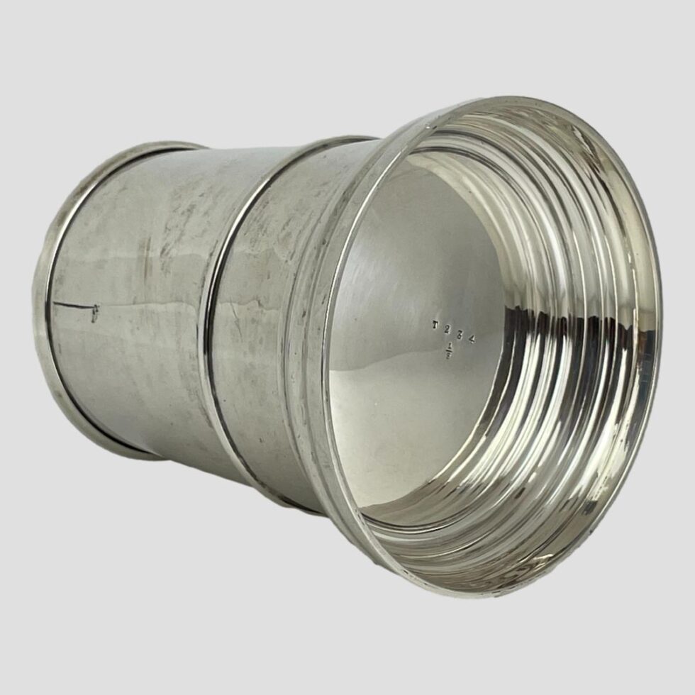 Photo of the base of the silver tankard showing numbers T234 and half sign.