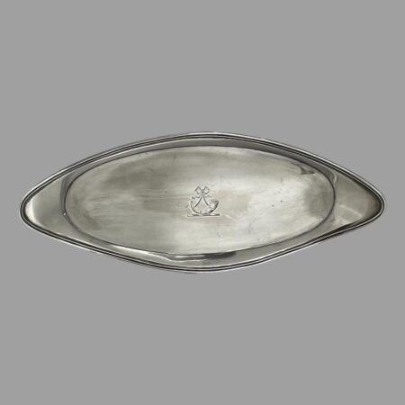 Main photo of George III snuffer tray displayed horizontally upright to show the shape of the tray which is an elongated oval with turned up or raised border. It is almost an eye or almond shape. The crest at the centre is visible which is a ribbon with what looks like a hunters horn of a stand (could be an old hearing aid horn!) Not a lot of use for snuffer trays these days but this could be utilised as an stick incense burner stand as it is long enough. Whatever you decide to use it for, it will be a useful and practical (as well as collectable) item of antique silver.