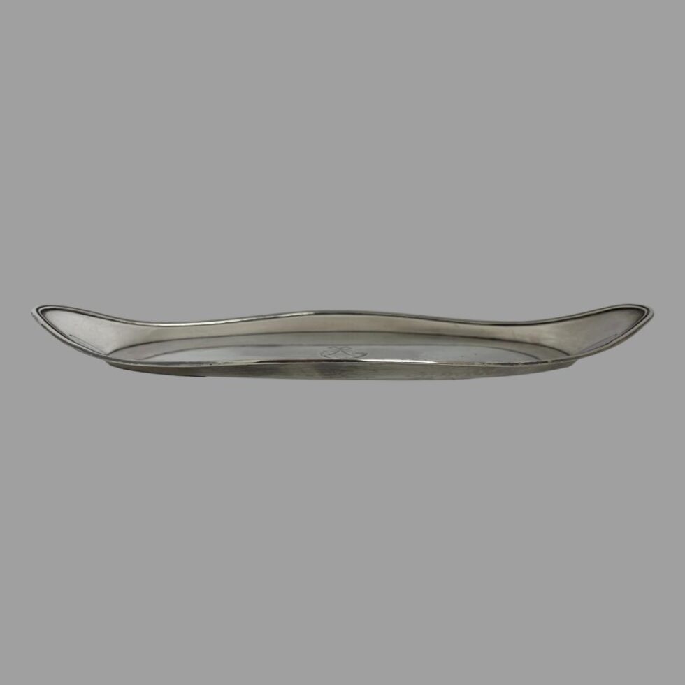 Photo of George III snuffer tray seen from a horizontal eye level to show the raised border which extends all around the tray.