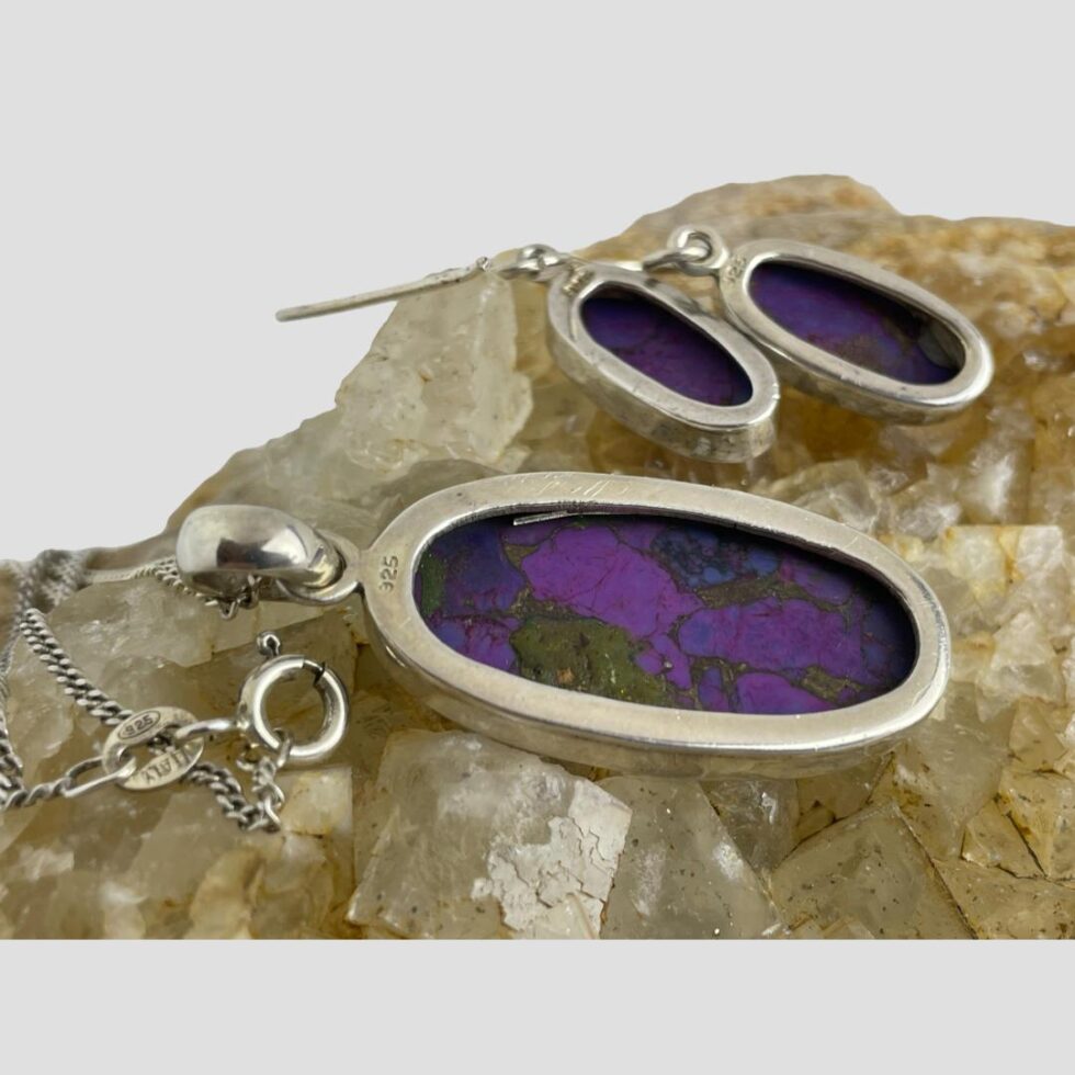Photo of the back of the earrings and pendant showing the 925 hallmark to each as well as the clasp of the chain which is just below the pendant.