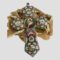 Main photo of micro mosaic papal cross displayed leaning against a rock of natural desert sand rose with the cross front on display. The mosaic colours are in red, white, blue and green with round brass open locket areas at the tips with pictures of famous Roman landmarks and in the centre is the largest picture with Pope Pius XII. The collar of the popes cloak has been hand coloured a pale pink which appears a little faded with time. The mosaic is in good order and nearly all present.