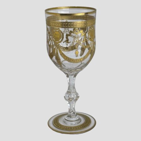 Main photo of St Louis Congress goblet seen from almost an eye level in its entirety. The side displayed shows the swag at centre with lions head discs either side. This is a very grand glass and would require some grand burgundy to put it into good respectful use!