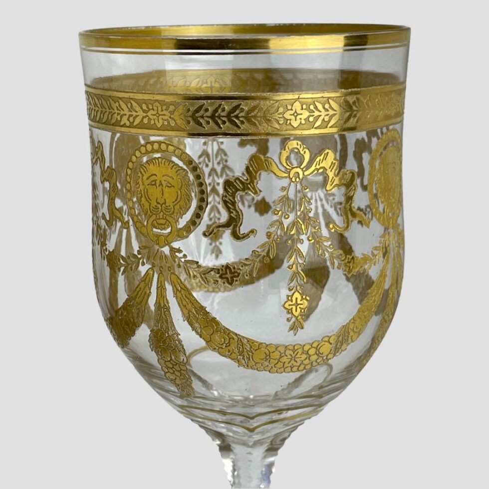 A close up of the swag and lion gilt detail to the top of glass.