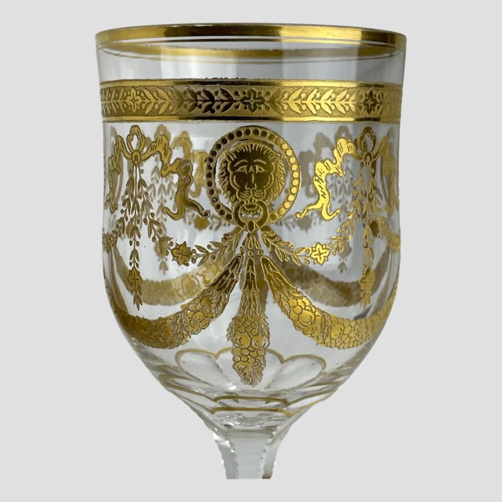 A close up photo of the top of glass this time showing one of the lion discs in the centre with the swag trailing off to left and right. So much gilt detail!