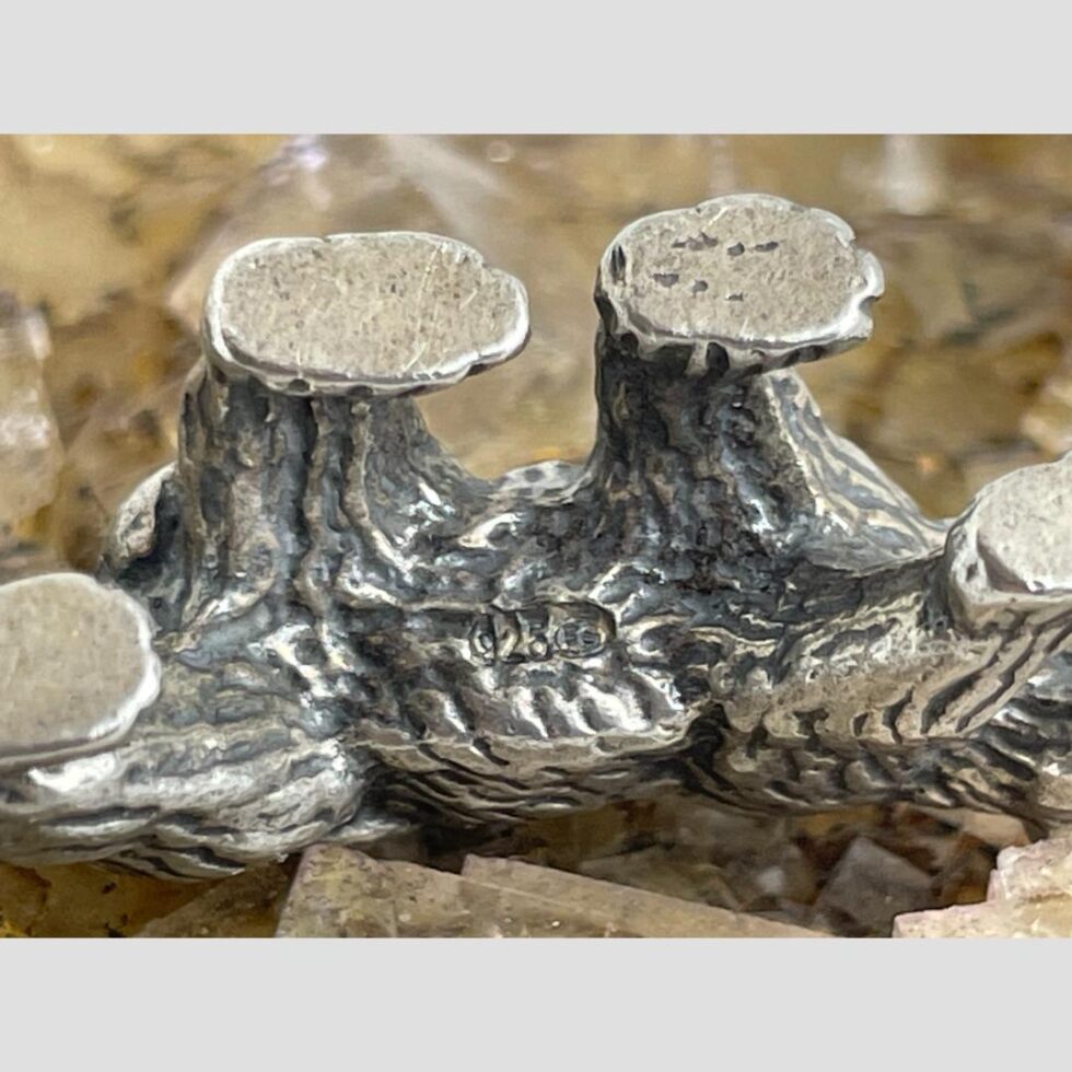 Photo of miniature silver bear showing its belly with all 4 paws up. This is to show the 925 hallmark and makers mark FS right in the centre of belly.