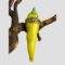 Main photo of Limoges yellow chilli box displayed leaning upright on a twig with the opening side with snail on display. Beautifully hand-painted and looking very real if it wasn't for the brass band at the top with the snail. Green topped and tapered to a chilli point at the end, this is a mild chilli of a lemon yellow colour.