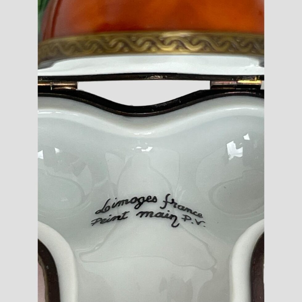 Close up photo of the signature to the inside of Limoges cherry box which read 'Limoges France Peint Main P.V.'