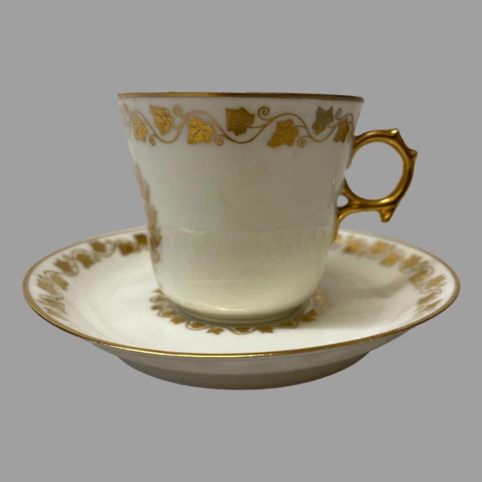 Photo of the antique Sêvres Cup &Saucer this time with the cup on top of the saucer and seen from a side view with the gilt handle to the right.