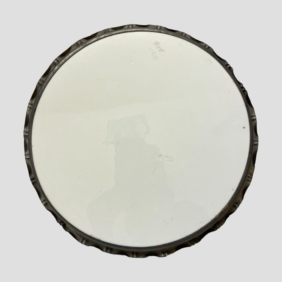 Photo of the base of the Limoges metal rimmed tray. There are some etched numbers visible.