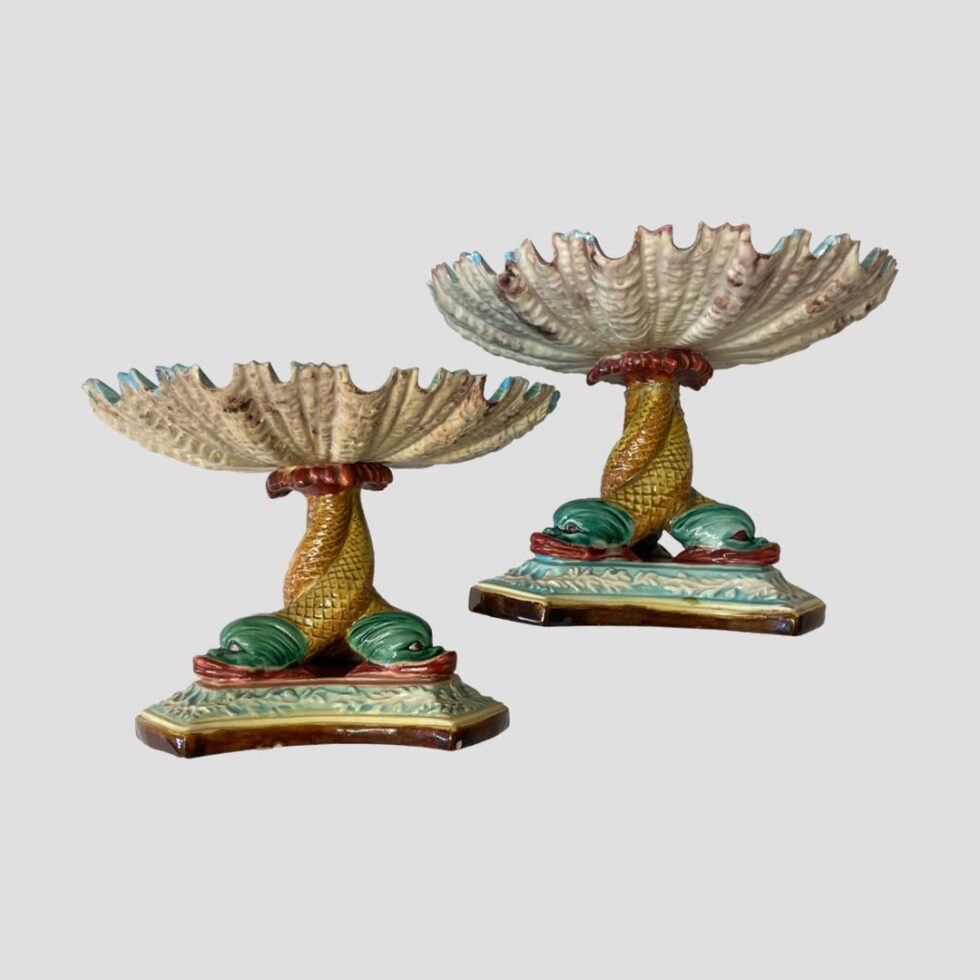 Photo of the sweetmeat dishes shown side by side with one on left slightly lower than other. The photo is taken from an eye level with the detail to scalloped shell bowls clearly visible.