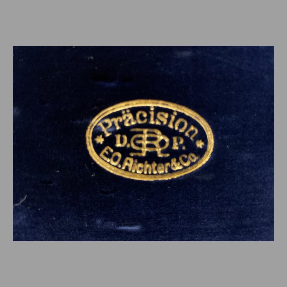 Close up photo of the Richter & Co stamp in gold on the inside of lid.