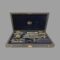 Main photo of Richter & Co precision set showing open case seen from the front opening end with all the instruments in their place. Makers stamp in gold to the centre of the velvet lining on inside lid. Apart from maybe one definitely missing piece (visible space at centre front), there is something very satisfying about looking into a box of precision tools neatly laid out in their allotted slots.