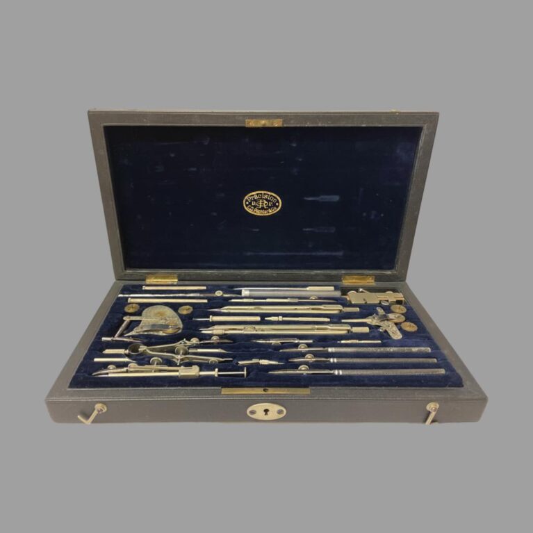 Main photo of Richter & Co precision set showing open case seen from the front opening end with all the instruments in their place. Makers stamp in gold to the centre of the velvet lining on inside lid. Apart from maybe one definitely missing piece (visible space at centre front), there is something very satisfying about looking into a box of precision tools neatly laid out in their allotted slots.