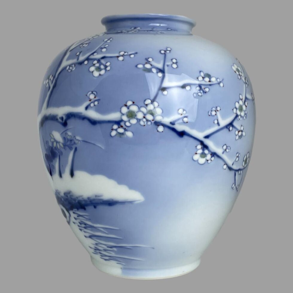 The Fukagawa vase has now been turn to the left showing a section of snow covered white winter plum and ground. The branch goes all across the vase side from left to right along a central line. There are a few sides to this vase which can be displaying giving options on preference of scene.