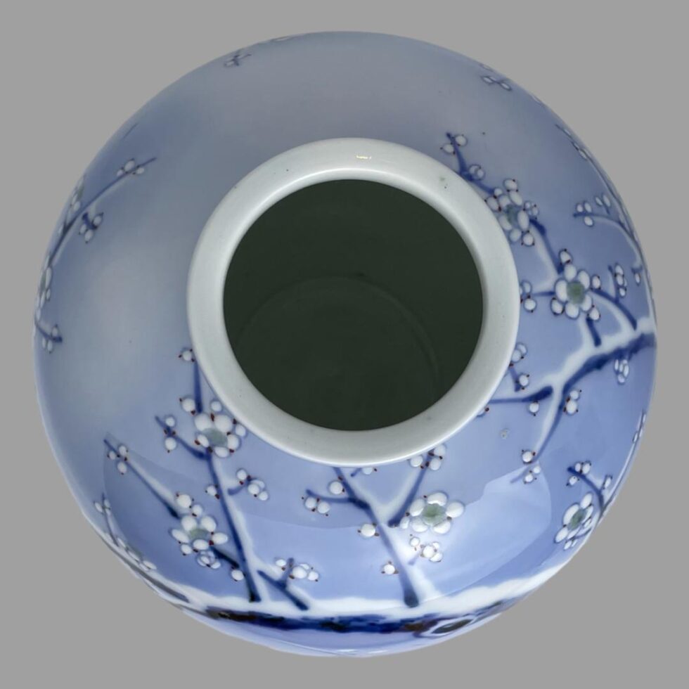 Photo looking straight down into the mouth of the Fukagawa Seiji vase. Some of the blossoming white winter plum can be seen around the mouth.