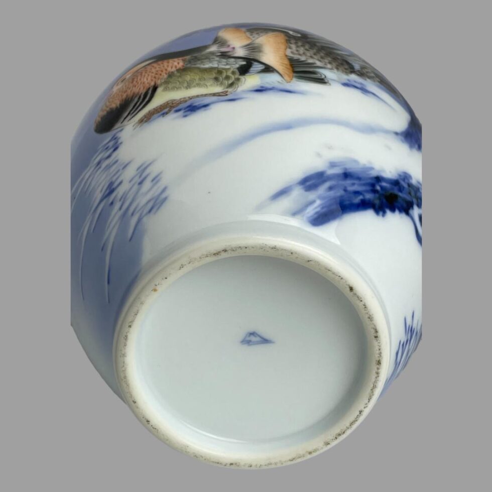 Photo of the Fukagawa vase laid on its side to show the makers iconic mark of Mount Fuji with stream in front.