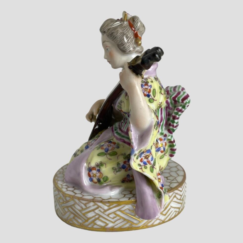 Photo of shamisen geisha this time facing directly to the left showing her in full profile. Every position of this figurine is a delight!