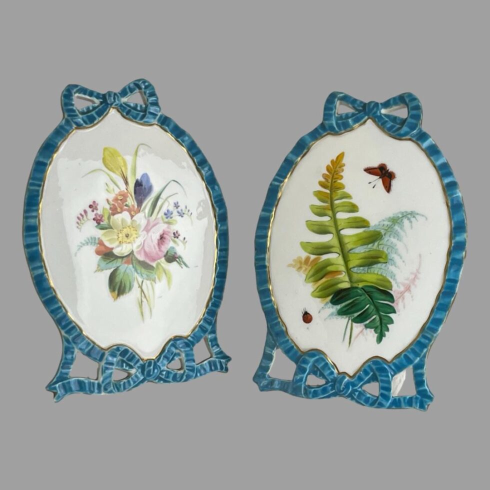 A photo of the pair of Minton porcelain pictures shown side by side. They would look beautiful one on each end of the mantlepiece or bookshelf.
