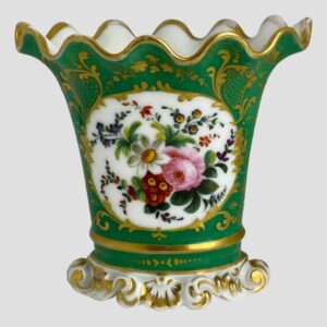 Main photo of Pairs scallop edged vase displayed with the decorative floral window side on show. The base colour of the vase is quite a breath taking shade of green - could be called green turquoise. The 'window' with flowers has a white background and there is a mixed bunch of flowers here in pink, blue, red, yellow and purple. Lovely gilt work extends over all the green turquoise area with dots and swirls. The base is white and moulded shape like sea froth with some gilt work. The top of the vase flutes outward with scalloped edge. The vase is in lovely condition but for the gilt wear around the rim which is quite extensive but could easily be touched up by someone with steady hands. Very pretty vase with or without flowers.