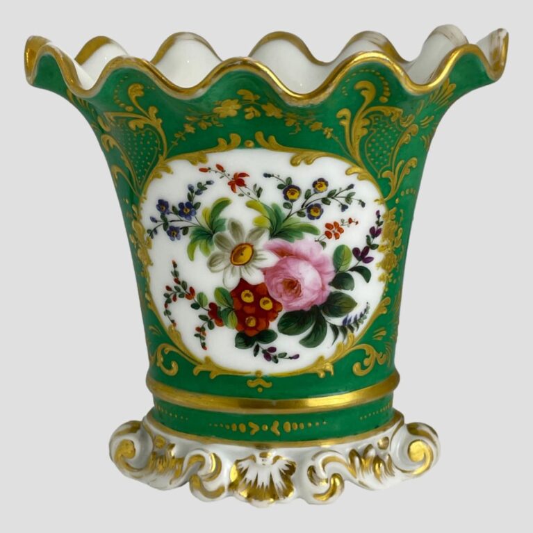 Main photo of Pairs scallop edged vase displayed with the decorative floral window side on show. The base colour of the vase is quite a breath taking shade of green - could be called green turquoise. The 'window' with flowers has a white background and there is a mixed bunch of flowers here in pink, blue, red, yellow and purple. Lovely gilt work extends over all the green turquoise area with dots and swirls. The base is white and moulded shape like sea froth with some gilt work. The top of the vase flutes outward with scalloped edge. The vase is in lovely condition but for the gilt wear around the rim which is quite extensive but could easily be touched up by someone with steady hands. Very pretty vase with or without flowers.
