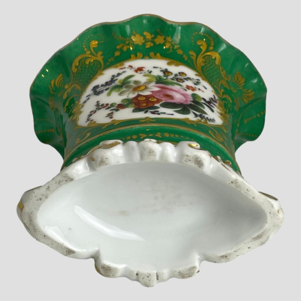 Photo of the scallop edged vase laid on a flat surface with floral side up and showing the plain white base which has no markings.