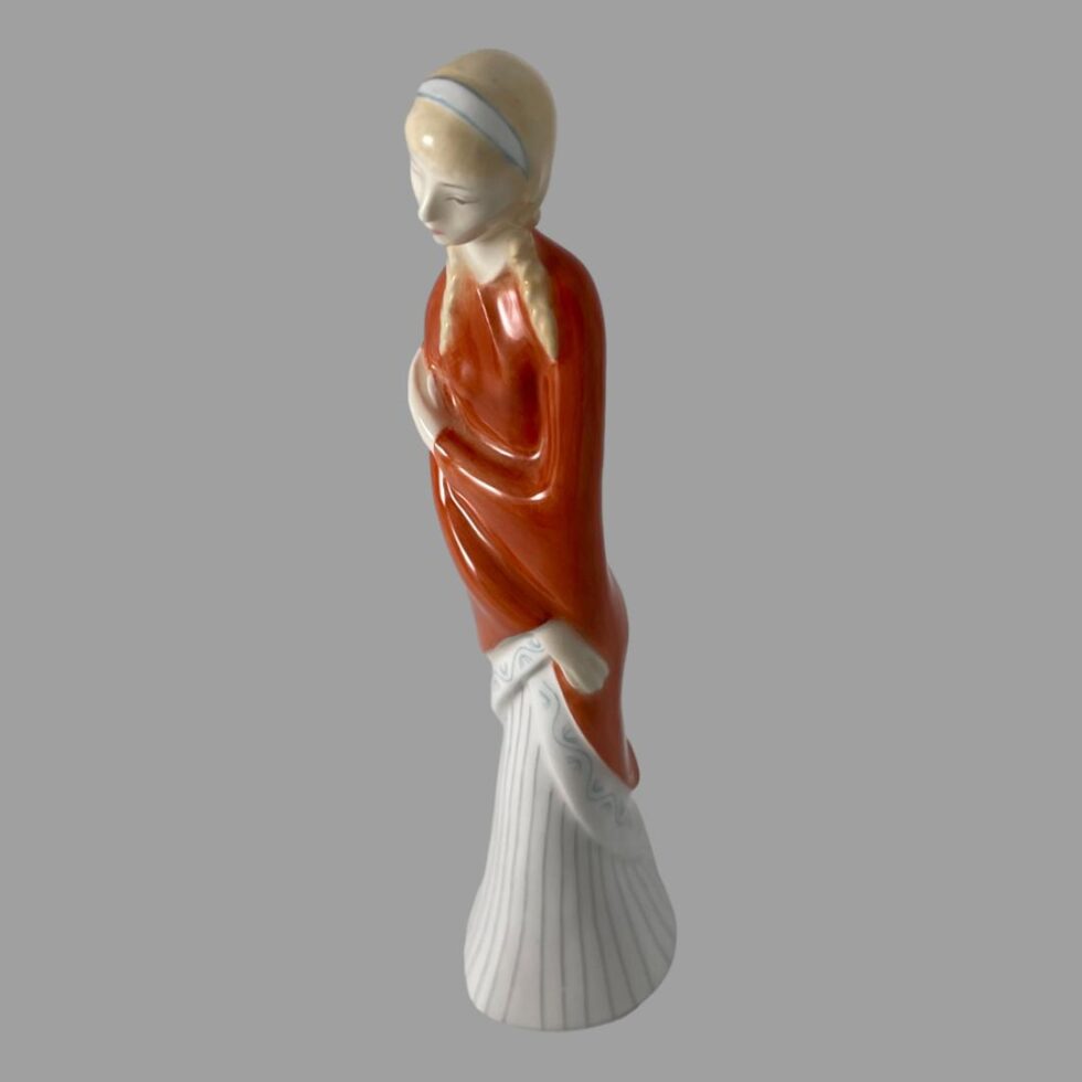 Photo of Doulton teenager seen this time from a slightly raised angle looking diagonally downward with the figure facing towards the bottom left.