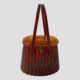 Main photo of 50s acetate moulded purse seen forward facing with the 2 handles upright. The bag appears like a large piece of different coloured amber. The lower part of the bag a dark cognac, the handles are darker shade of cognac to the body and the lid a honey amber hue.