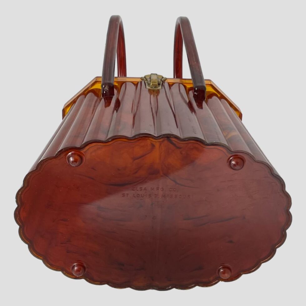 Photo of the base of the moulded acetate purse showing the 4 little bubble feet and the makers details.