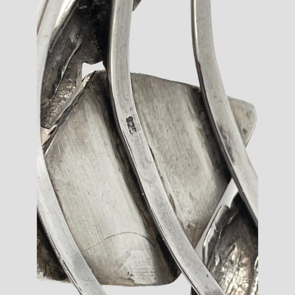 Close up photo of the 925 silver hallmark on the back of the cuff (on the middle band behind the red onyx)