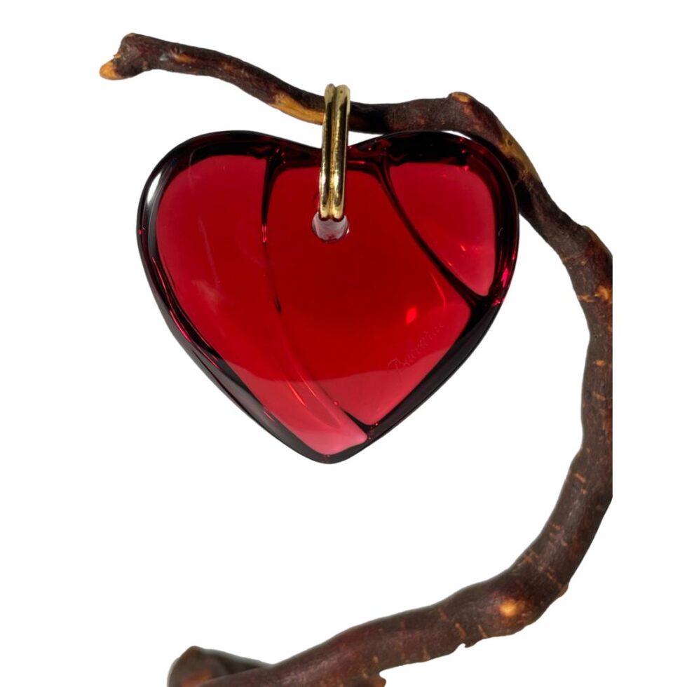 Photo of the back of the Baccarat heart pendant still hanging from the thin twig.