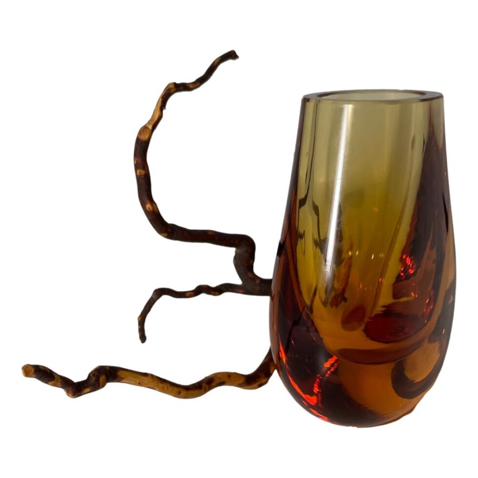 Photo of the hambone vase this time seen from a side angle to show the depth. The dried twig is still to the left.