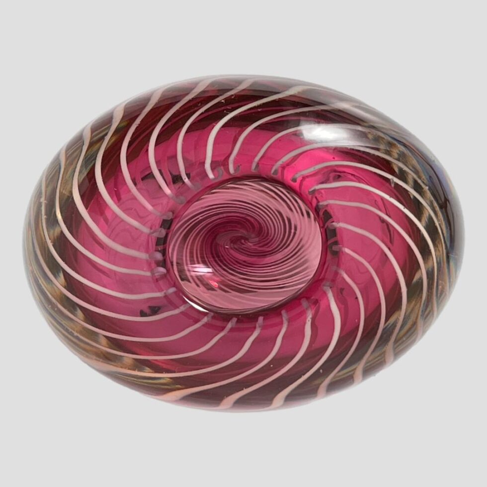 Photo looking straight down into the mouth of the vase from above. - quite an optical illusion going on here! This vase is hand blown in pink glass with internal white spiral filigree threads. Those threads are creating an interesting illusion in this photo!
