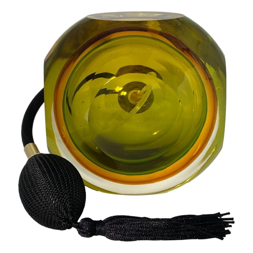 Photo of the base of the Murano perfume atomiser showing the different colours within clearly. The atomiser is on the left and swirled out in front.