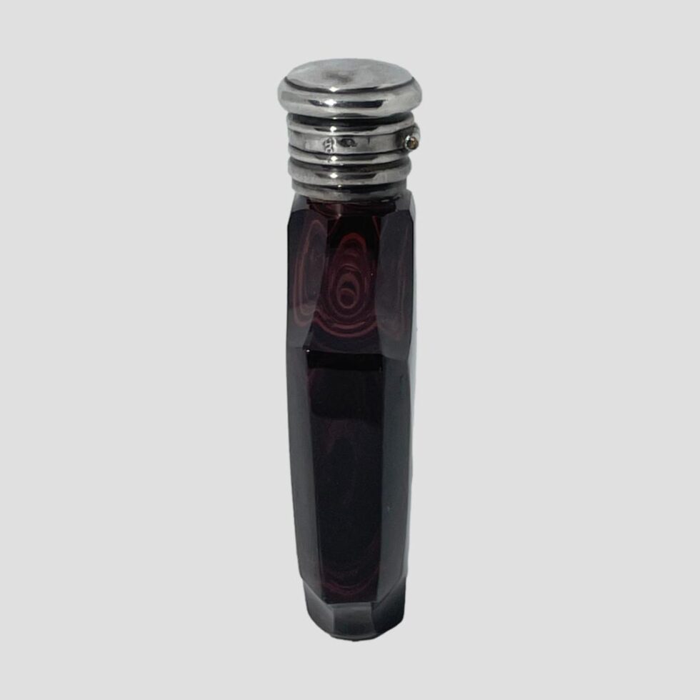 Photo of French scent bottle this time from the side width angle. The bottle has the same depth as the opening silver top so quite slim little number ideal for smelling divine on the move!