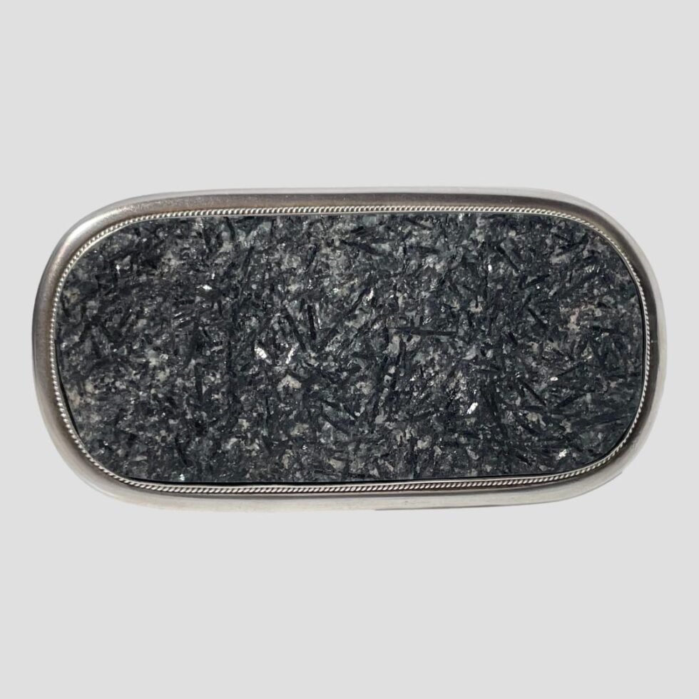 Photo of the front of the tourmaline brooch propped upright by its own pin.
