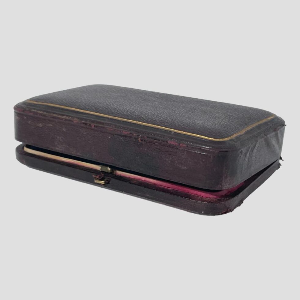 Photo of the case with lid closed but not shut. The outside of case has some wear