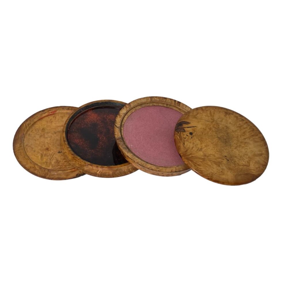 The underside of all 4 sections showing the opposite side to previous photo. Bottom of base, Pink card (?) lining, tortoiseshell like lining, wood to underside of lid.