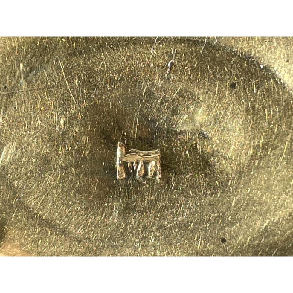 Close up photo of the William Lestourgeon hallmark inside the gilt interior of box.