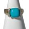 Main photo of 14kt turquoise diamond ring displayed on a white cone shaped stand and forward facing. The turquoise is almost flawless with just a small dark line inclusion. On either side are thin columns that run alongside the curve of the cushion cut turquoise. Each column has 5 round cut diamonds. The 14 karat gold band is solid and the shoulders are almost the width of the turquoise, tapering to a slightly thinner band at the back.